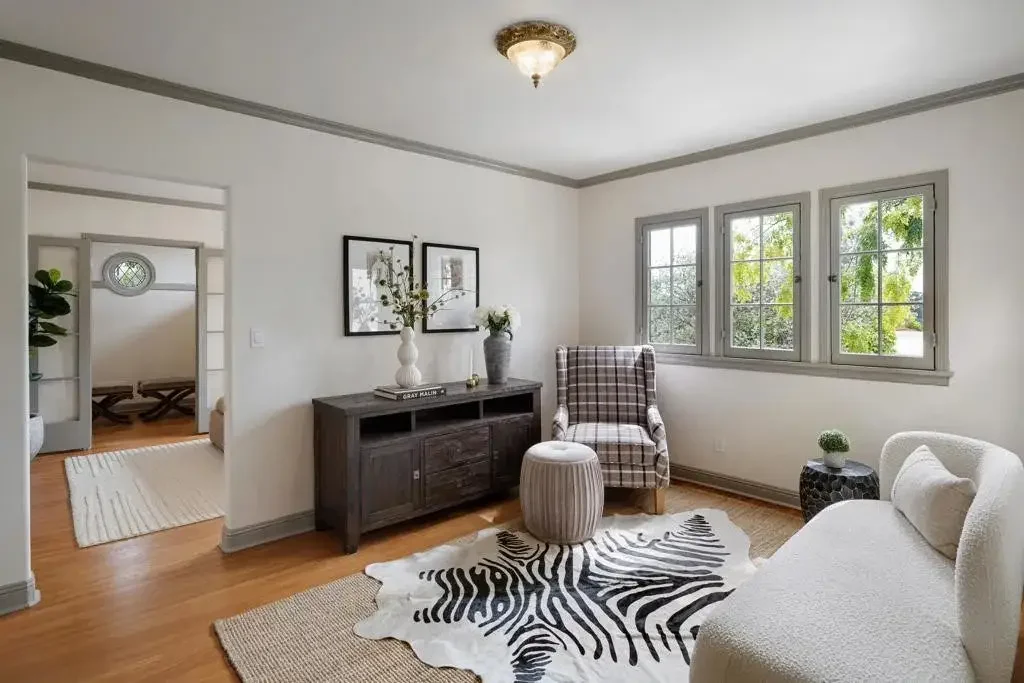 Light-filled sitting room with wood flooring and a window