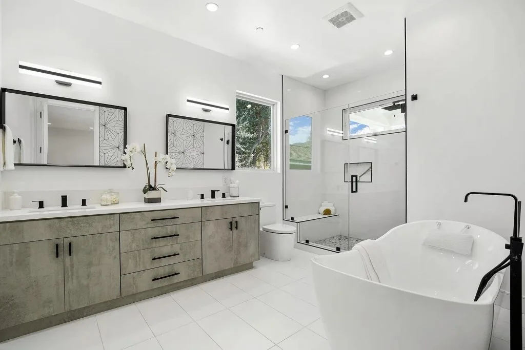 Remodeled bathroom with a double vanity and freestanding tub