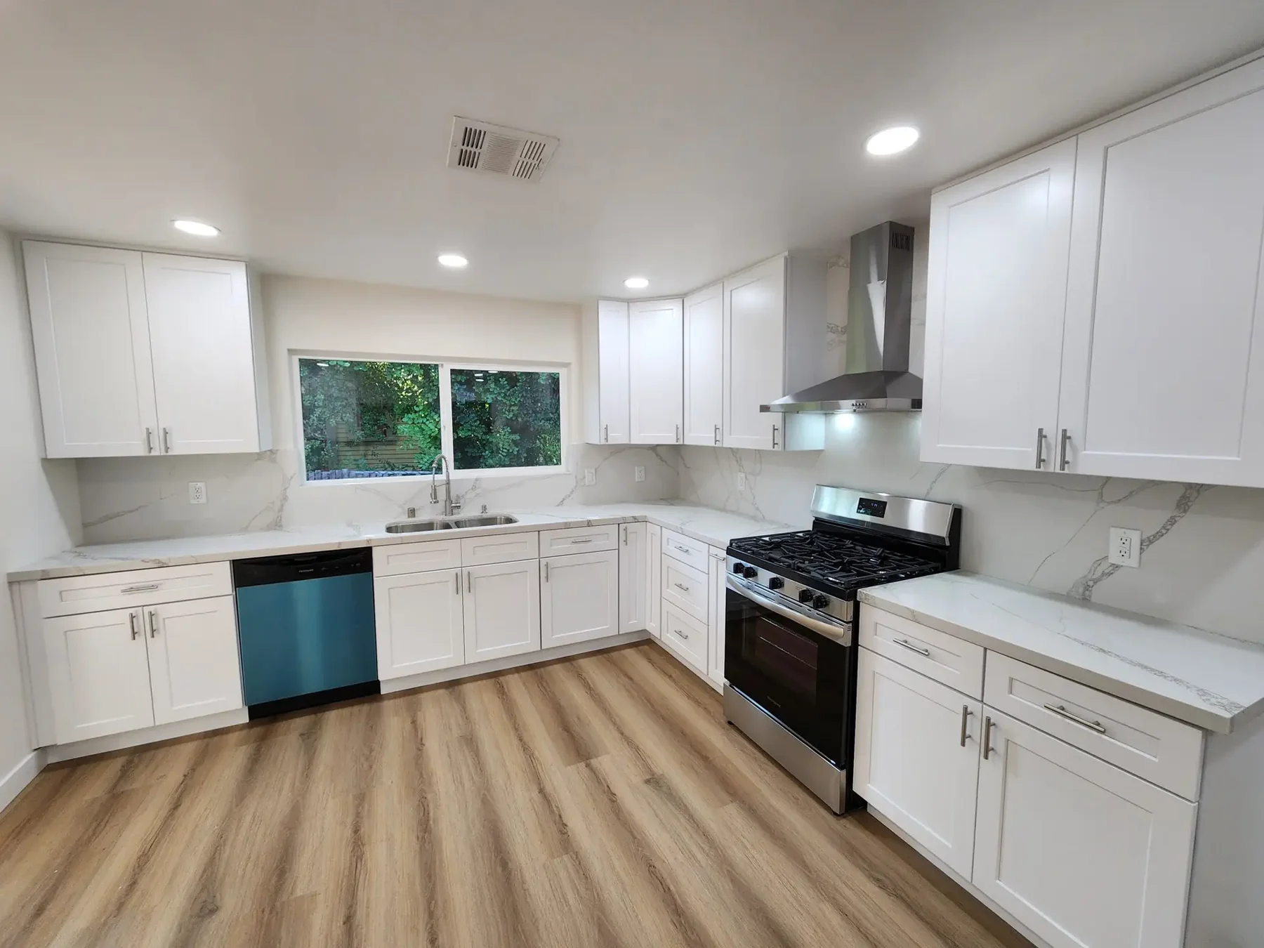 Remodeled kitchen with white cabinetry